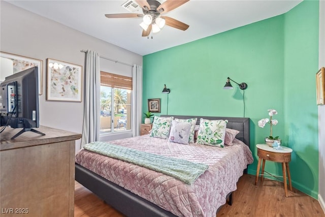 bedroom with ceiling fan and hardwood / wood-style flooring