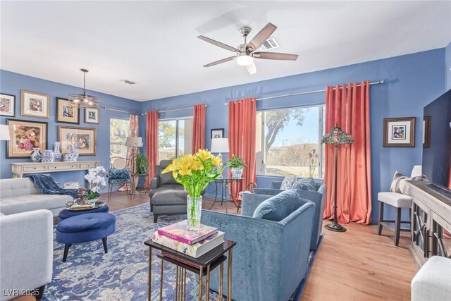 living room with ceiling fan and light wood-type flooring