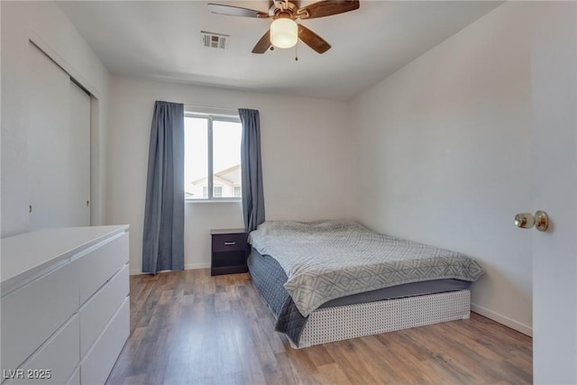 bedroom featuring hardwood / wood-style floors, a closet, and ceiling fan