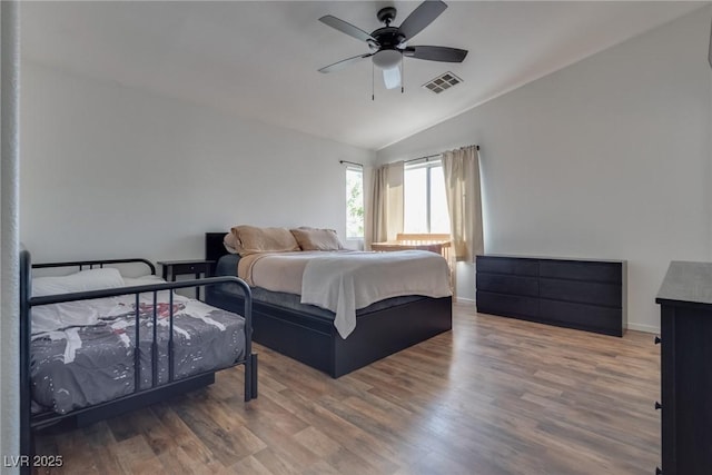 bedroom featuring lofted ceiling, wood-type flooring, and ceiling fan