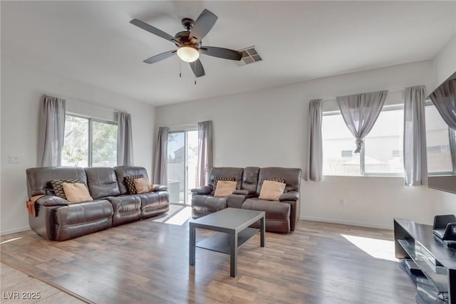 living room with hardwood / wood-style flooring and ceiling fan