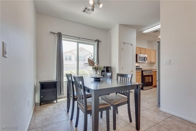 dining area featuring light tile patterned floors