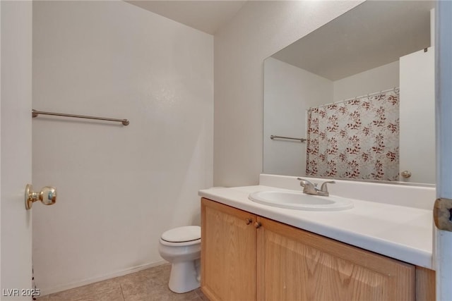 bathroom featuring toilet, vanity, and tile patterned flooring