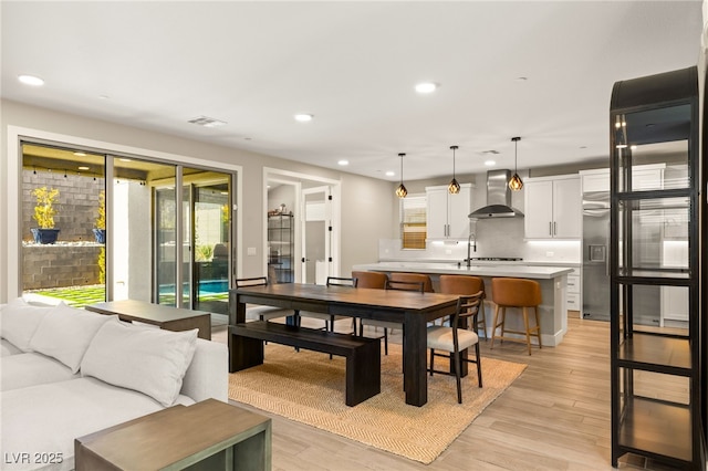 dining area featuring sink and light hardwood / wood-style floors