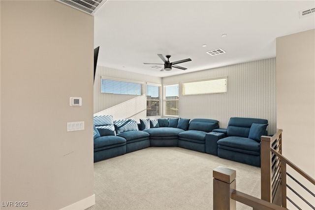 carpeted living room with ceiling fan