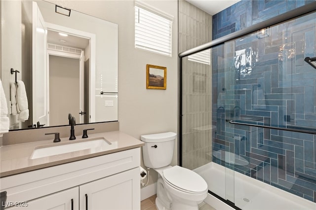 bathroom with toilet, vanity, and walk in shower