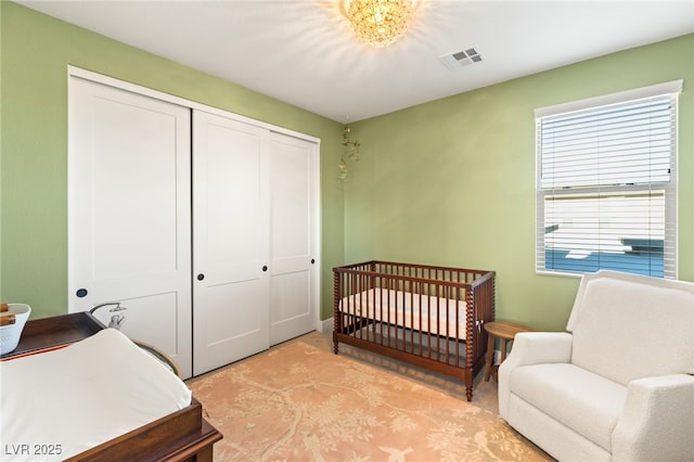 bedroom with a closet and a crib