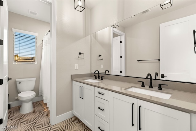 bathroom featuring toilet, tile patterned flooring, and vanity