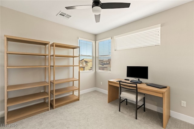 home office with ceiling fan and light carpet