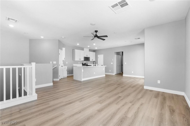 unfurnished living room with ceiling fan and light hardwood / wood-style flooring