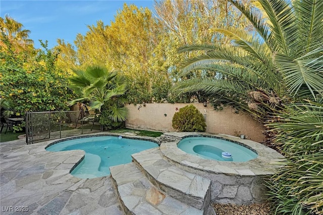 view of swimming pool featuring an in ground hot tub