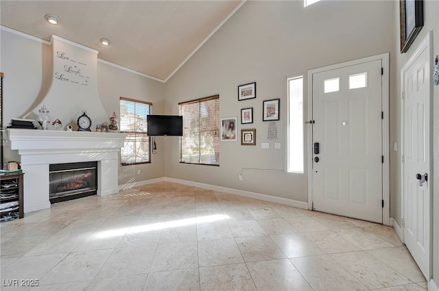 interior space featuring ornamental molding and high vaulted ceiling