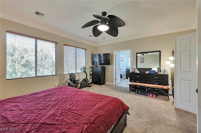 bedroom featuring ceiling fan, ensuite bath, ornamental molding, and light colored carpet