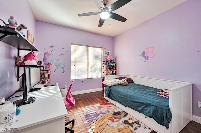 bedroom with dark hardwood / wood-style floors and ceiling fan