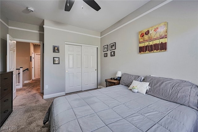 bedroom with ceiling fan, light carpet, and a closet