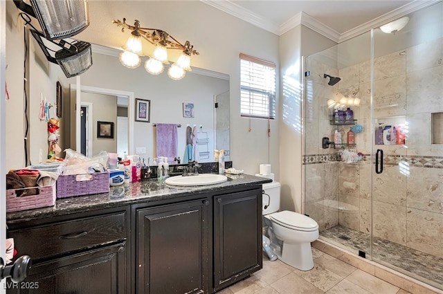 bathroom with tile patterned floors, toilet, a shower with shower door, crown molding, and vanity