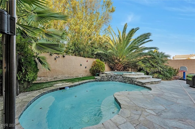 view of swimming pool featuring an in ground hot tub and a patio area