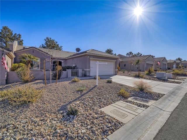 single story home featuring stucco siding, an attached garage, driveway, and fence