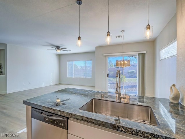 kitchen with sink, ceiling fan, pendant lighting, and stainless steel dishwasher