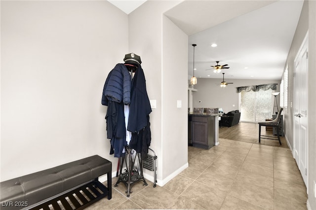 corridor with lofted ceiling and light tile patterned flooring