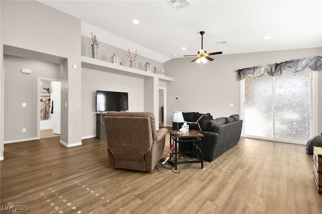 living room featuring vaulted ceiling, ceiling fan, and wood-type flooring