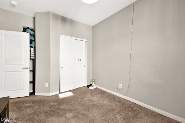 unfurnished bedroom with dark colored carpet