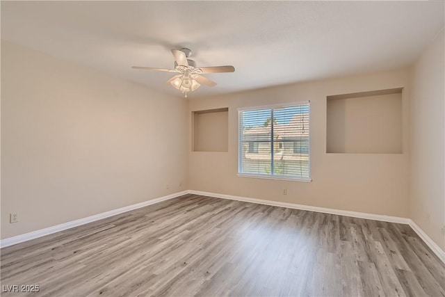 spare room with ceiling fan and light hardwood / wood-style flooring