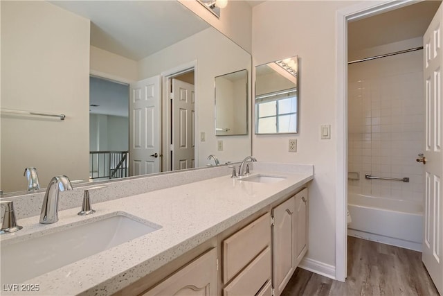 full bathroom featuring vanity, washtub / shower combination, hardwood / wood-style floors, and toilet