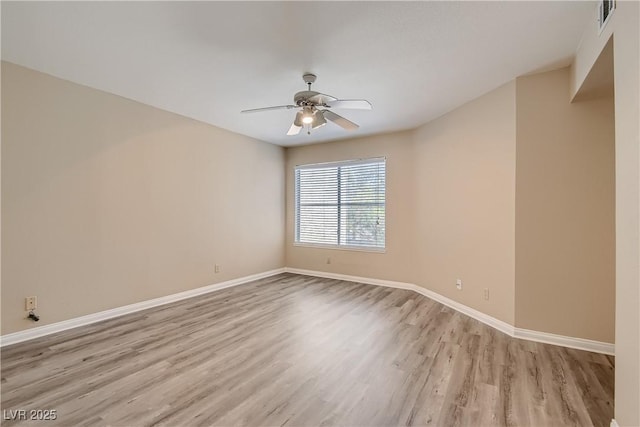 spare room with light wood-type flooring and ceiling fan