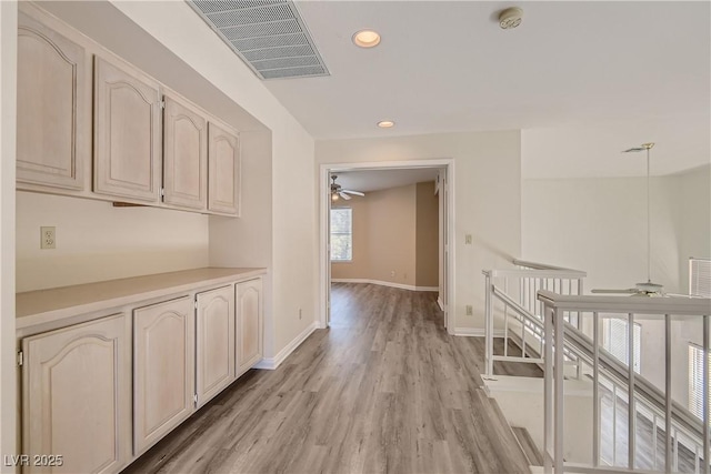 hallway with light hardwood / wood-style floors