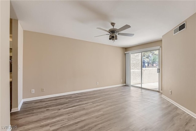 spare room featuring ceiling fan and light hardwood / wood-style floors