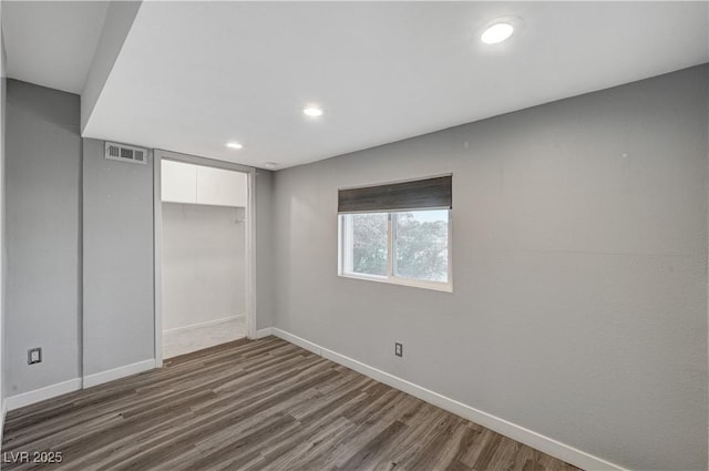 unfurnished bedroom featuring a closet and dark wood-type flooring