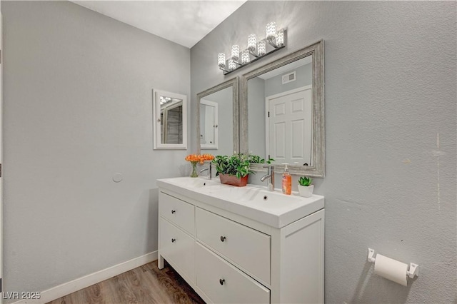 bathroom featuring hardwood / wood-style floors and vanity