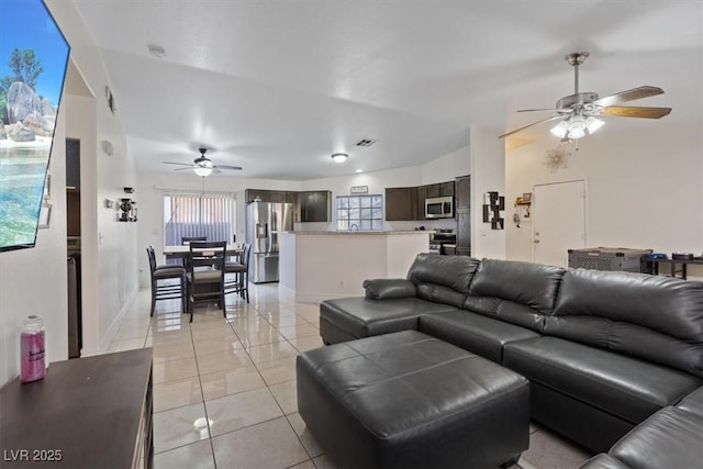 living room with light tile patterned floors and ceiling fan