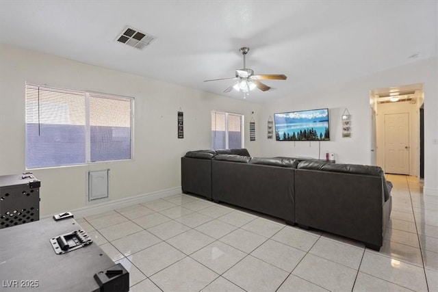 tiled living room featuring ceiling fan and a healthy amount of sunlight