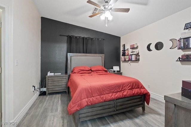 bedroom with ceiling fan and hardwood / wood-style floors