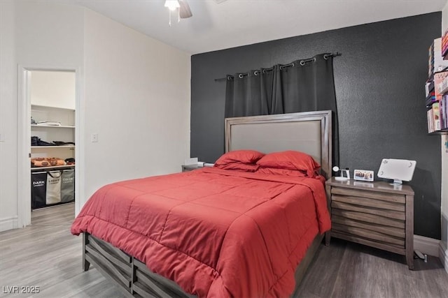 bedroom featuring wood-type flooring and ceiling fan