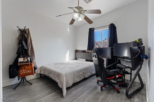 bedroom with ceiling fan and hardwood / wood-style flooring