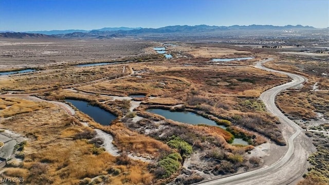 aerial view featuring a water and mountain view