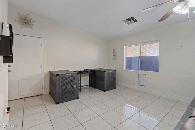 interior space with light tile patterned flooring and ceiling fan