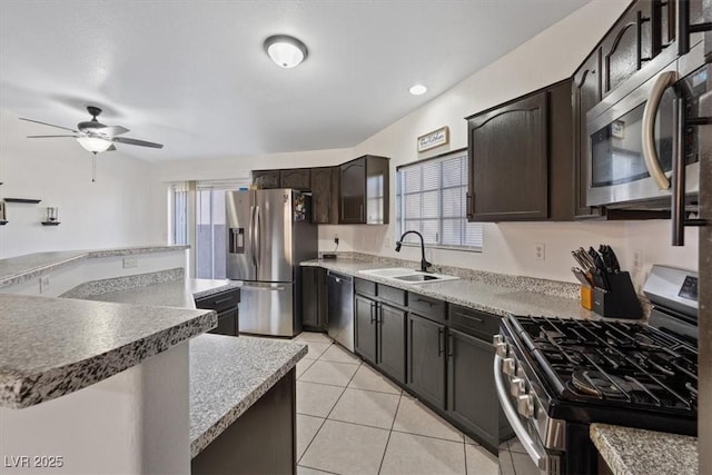 kitchen with sink, a wealth of natural light, light tile patterned floors, and stainless steel appliances