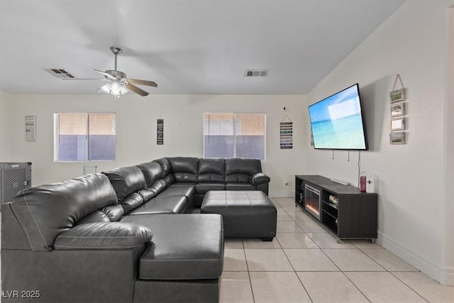 tiled living room featuring ceiling fan and a wealth of natural light