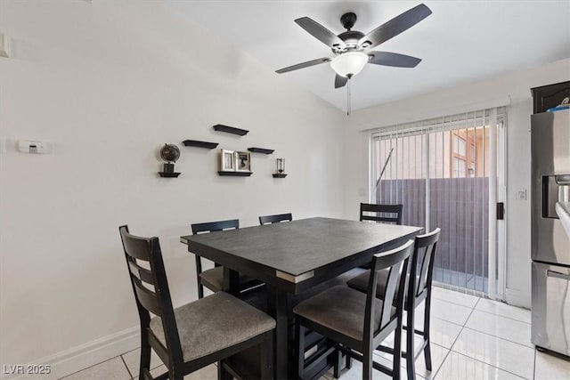 tiled dining area with ceiling fan