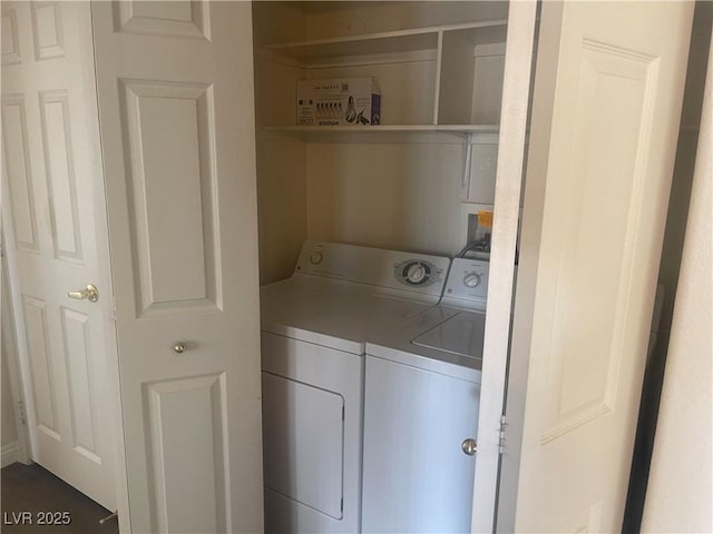 clothes washing area with washing machine and dryer