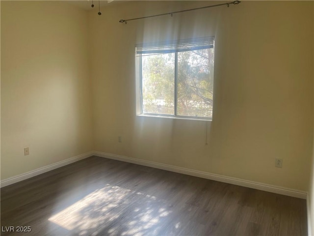 unfurnished room with dark hardwood / wood-style floors