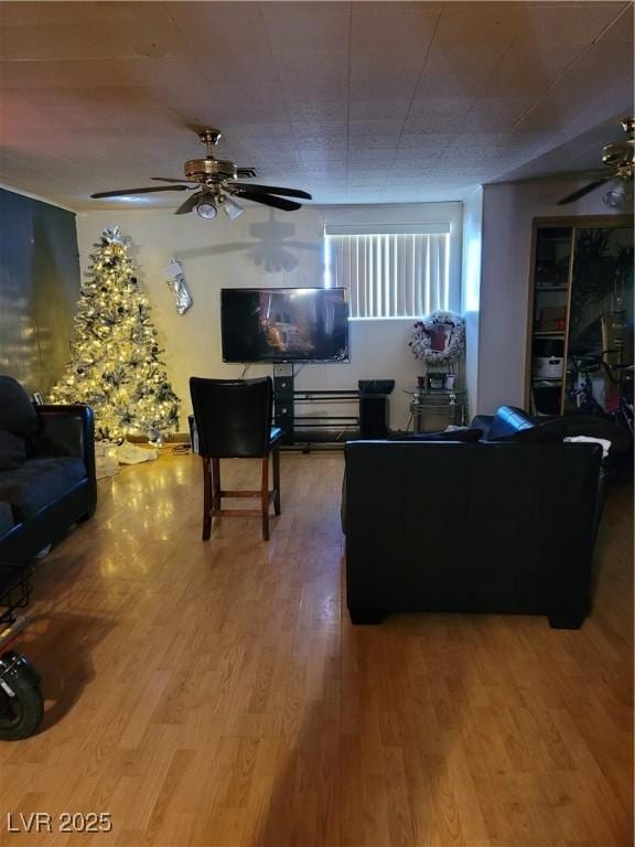 living room featuring ceiling fan and hardwood / wood-style floors