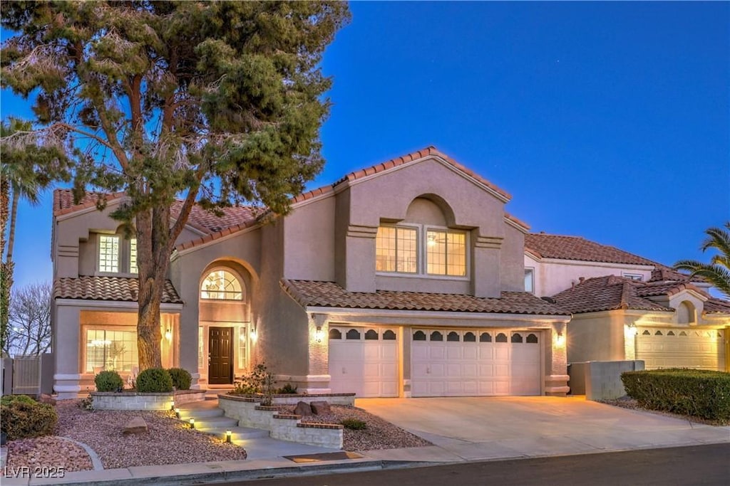 mediterranean / spanish home featuring a garage