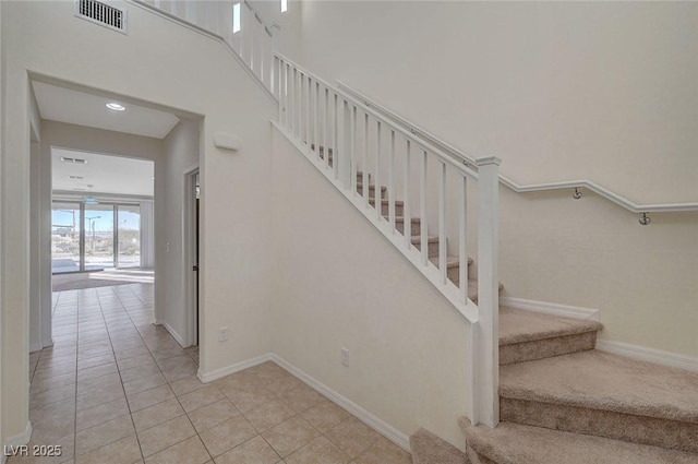 stairway featuring tile patterned floors