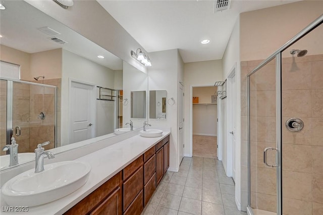 bathroom featuring vanity, tile patterned floors, and walk in shower