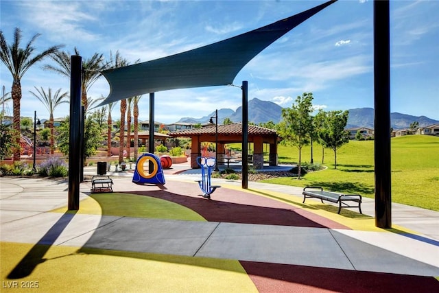 view of property's community with a gazebo, a mountain view, and a lawn